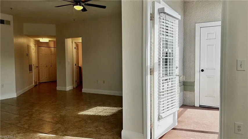 Corridor with dark tile patterned floors
