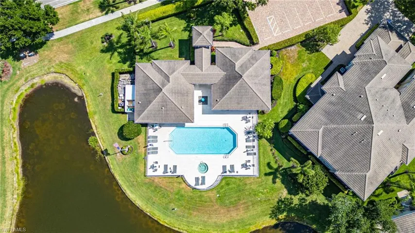 Expansive property featuring a large swimming pool, spa, and surrounding patio space