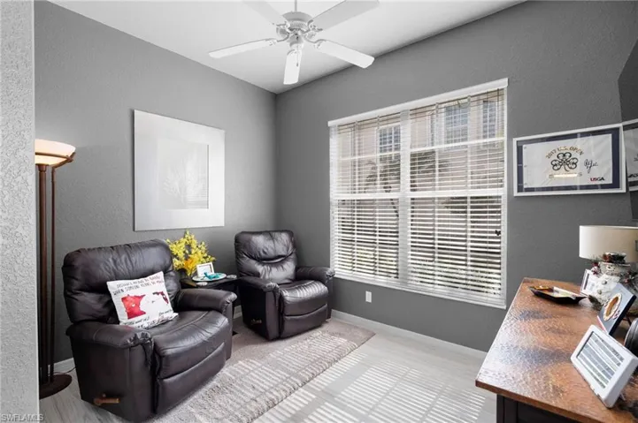Flex Room featuring light tasteful flooring, a white ceiling fan, and a large window with white blinds
