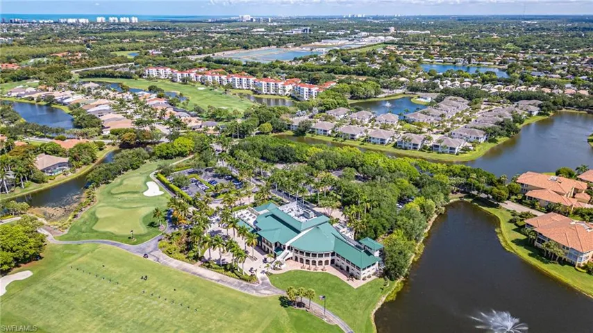 Expansive golf course and clubhouse with surrounding residential properties