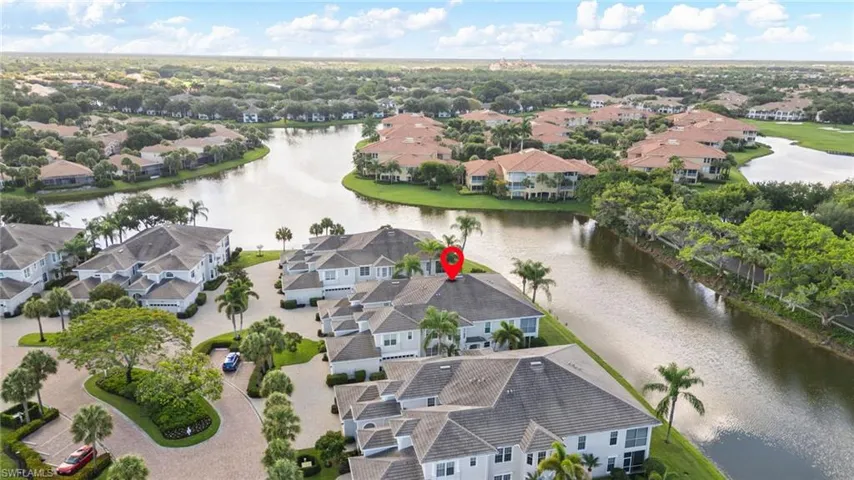 Aerial perspective showcasing a residential community with winding waterways, mature landscaping, and numerous properties