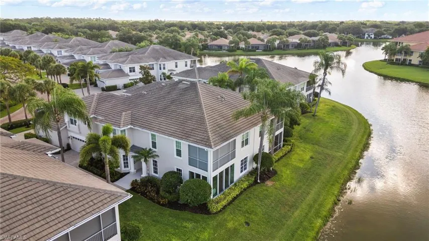 Two-story residence featuring a tile roof, screened lanai, and an attached two-car garage