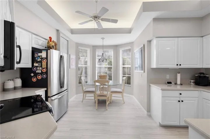 Kitchen featuring white shaker-style cabinetry, light-toned countertops, and stainless steel appliances