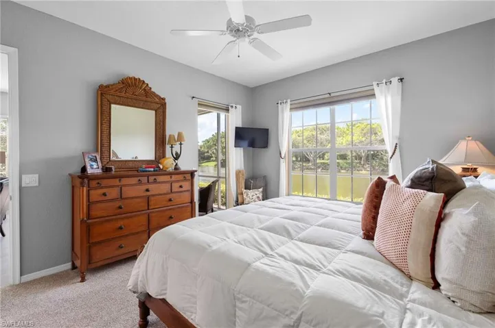 Main Bedroom with light gray walls, carpeted flooring, and a ceiling fan