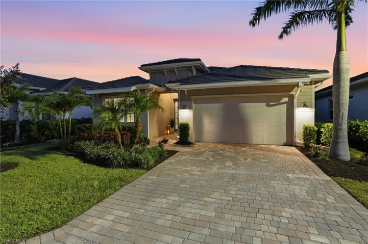 Twilight views, oversized garage, paved driveway, landscape