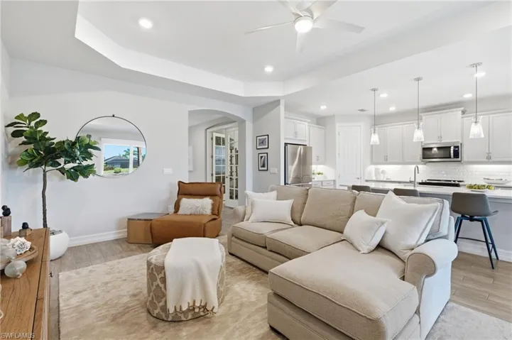 Living, dining overlooking pool area, lake