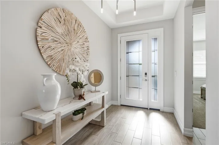 Foyer, leaded glass impact entry door, wood look tile flooring