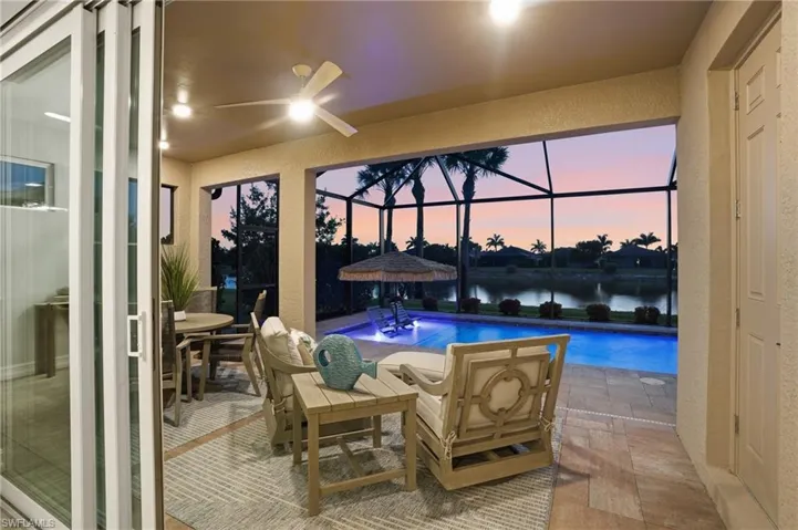 Screened lanai, travertine tiles, ceiling fan, lake views