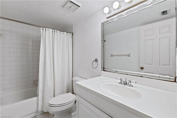 Guest bathroom with vanity, tub & shower