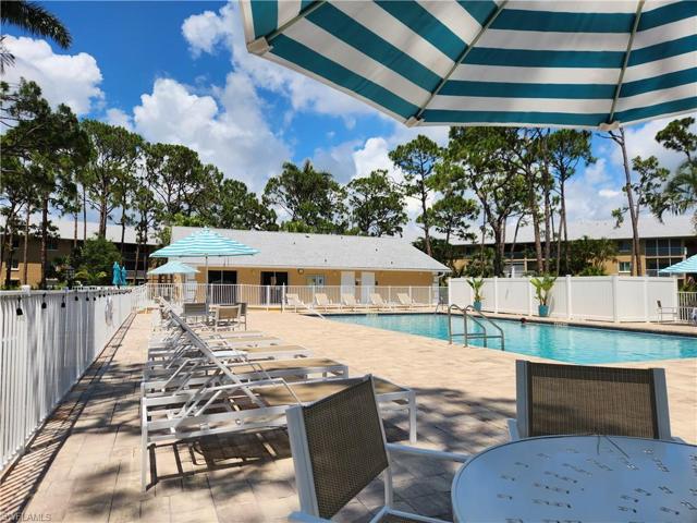 Large pool, deck, tables, chairs, & clubhouse