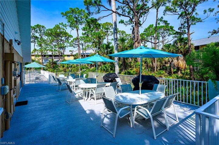 Clubhouse patio with tables, chairs & grills 1