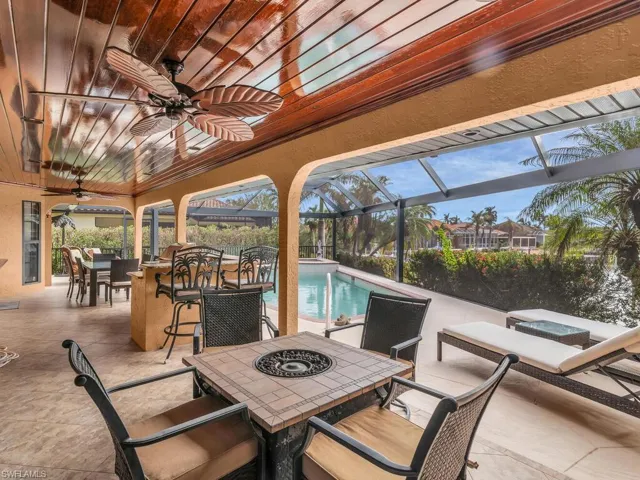 View of patio with glass enclosure and ceiling fan