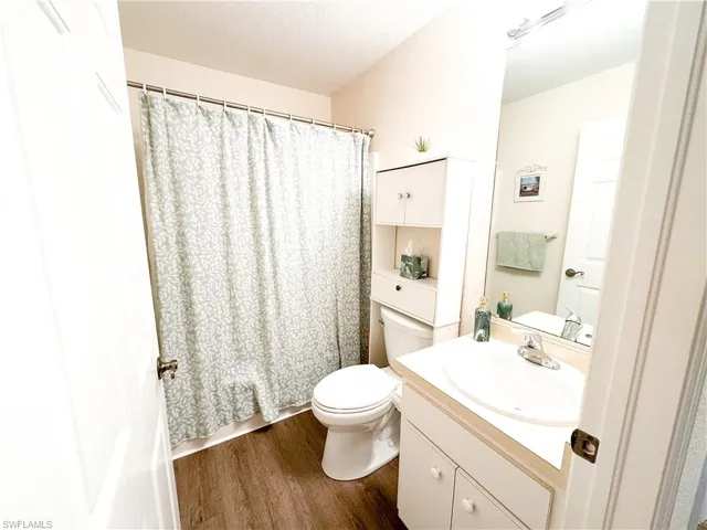 Bathroom featuring vanity and dark wood finished floors