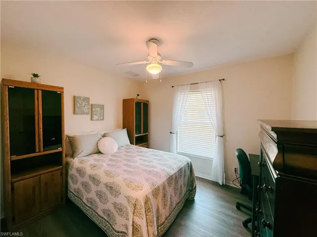 Bedroom with ceiling fan and wood finished floors