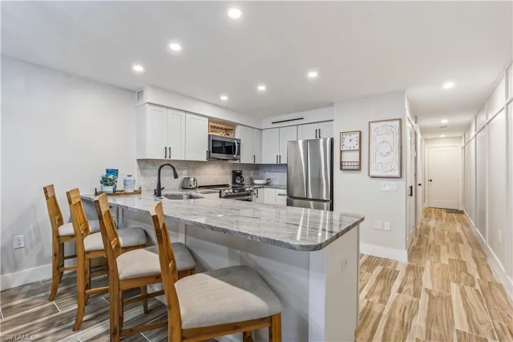 Kitchen with sink, a breakfast bar area, kitchen peninsula, and stainless steel appliances