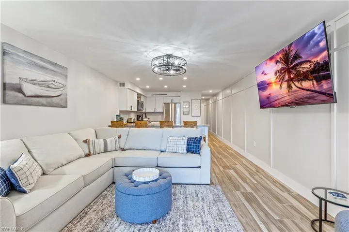 Living room featuring a chandelier and light hardwood / wood-style flooring