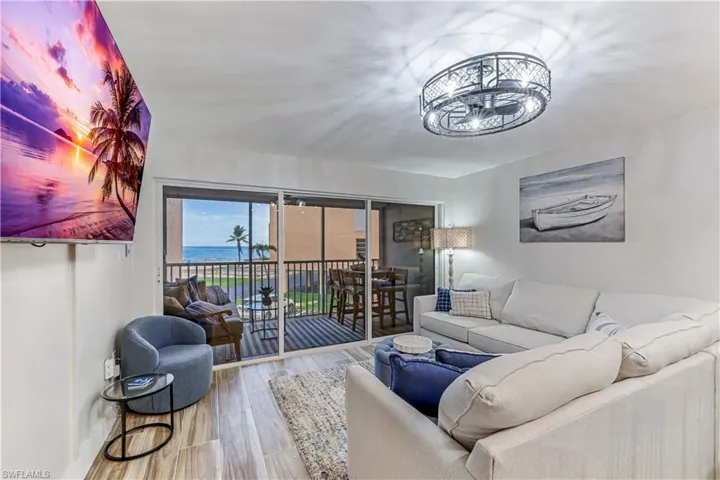 Living room featuring hardwood / wood-style flooring and a water view