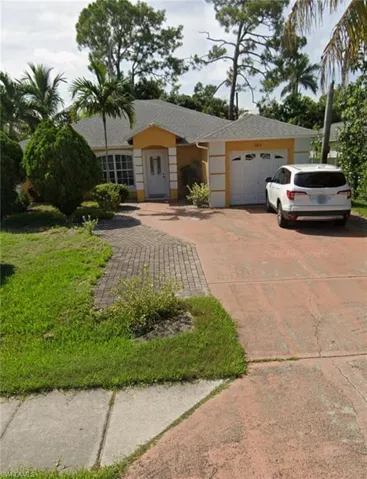 Ranch-style house featuring concrete driveway, an attached garage, stucco siding, and a shingled roof