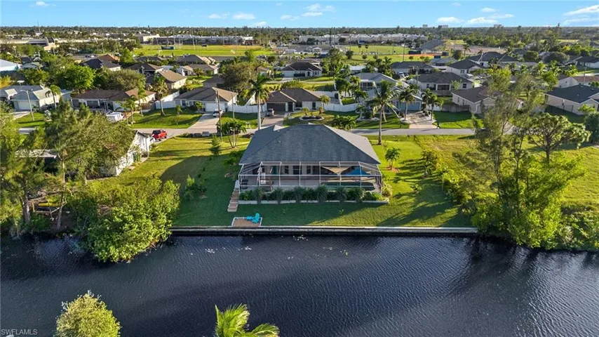 Birds eye view of property with a water view