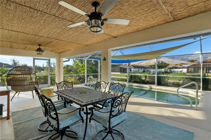 View of patio / terrace with ceiling fan and a lanai