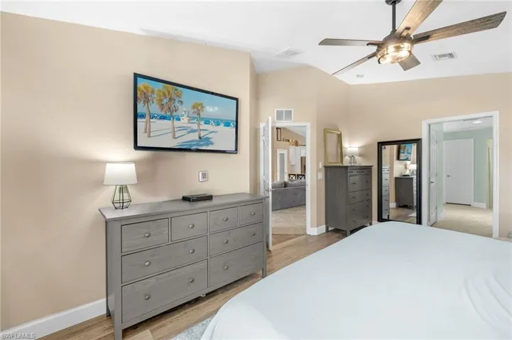 Bedroom featuring baseboards, light wood-type flooring, and ceiling fan
