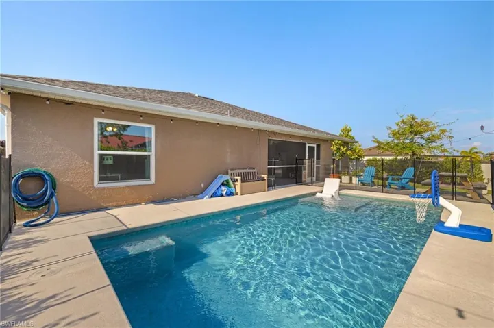 View of swimming pool featuring fence and a patio area