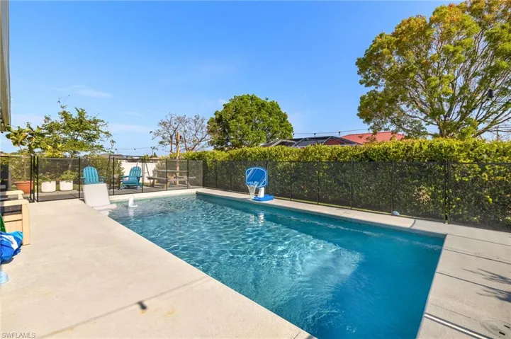 View of pool featuring fence and a patio area