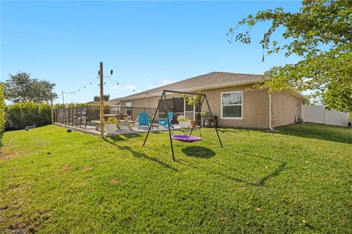 Rear view of property with stucco siding and a patio area