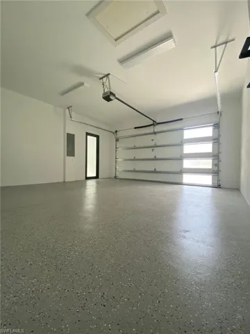 Garage with a garage door opener and Epoxy Flooring
