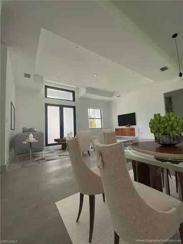 Virtually Staged-Dining room featuring finished concrete floors and baseboards