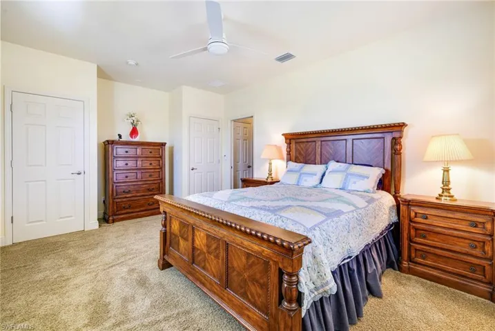 Bedroom featuring light carpet and a ceiling fan