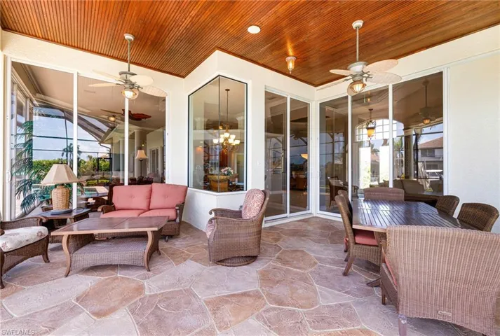 Sunroom / solarium featuring a ceiling fan, plenty of natural light, and outdoor lounge area