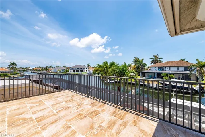 View of patio / terrace featuring a water view, a balcony, and a residential view