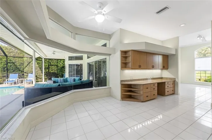 Kitchen with ceiling fan and light tile flooring