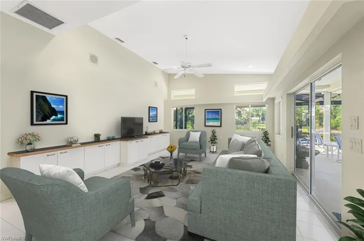 Virtually furnished.  Tiled family room with high vaulted ceiling