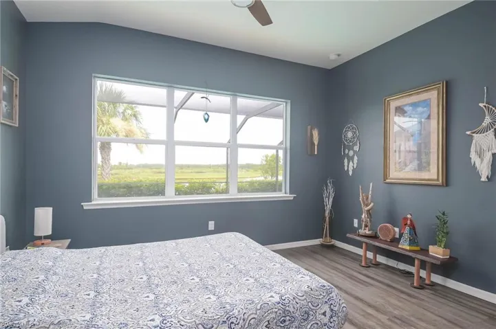 Bedroom featuring ceiling fan and hardwood / wood-style floors