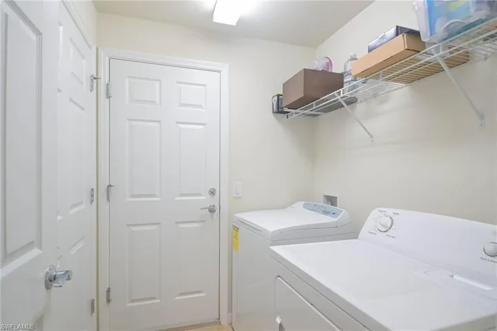 Laundry room with washer and clothes dryer