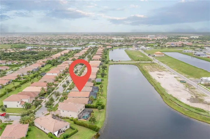 Birds eye view of property with a water view