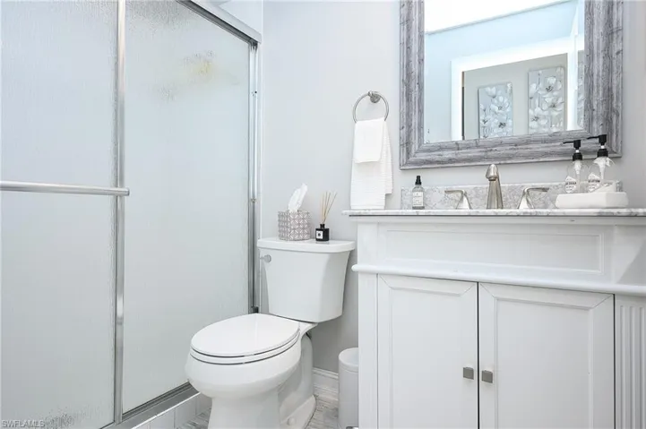 Full bath with a stall shower and vanity