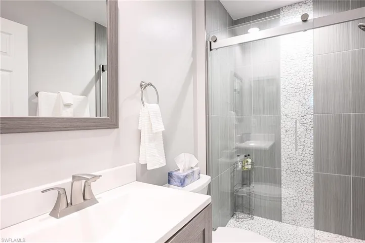 Bathroom featuring vanity and a stall shower
