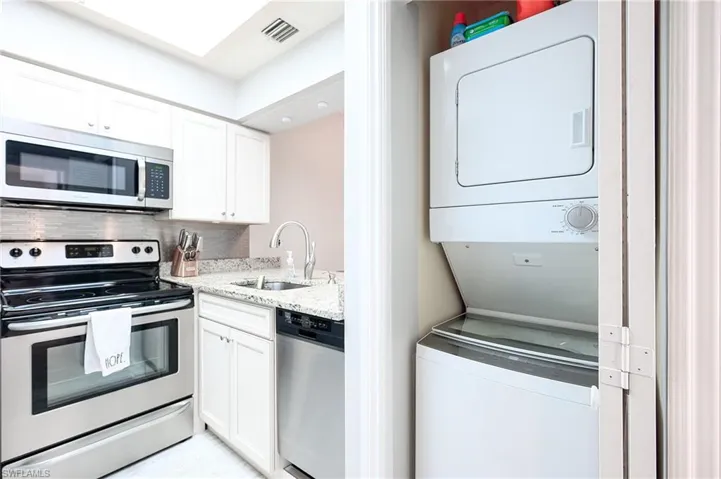 Kitchen/Laundry area, stacked washer / dryer, and