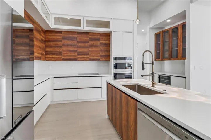 Modern kitchen with quartz counters, custom cabinets, stainless appliance package.