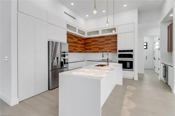 Modern kitchen with quartz counters, custom cabinets, stainless appliance package.