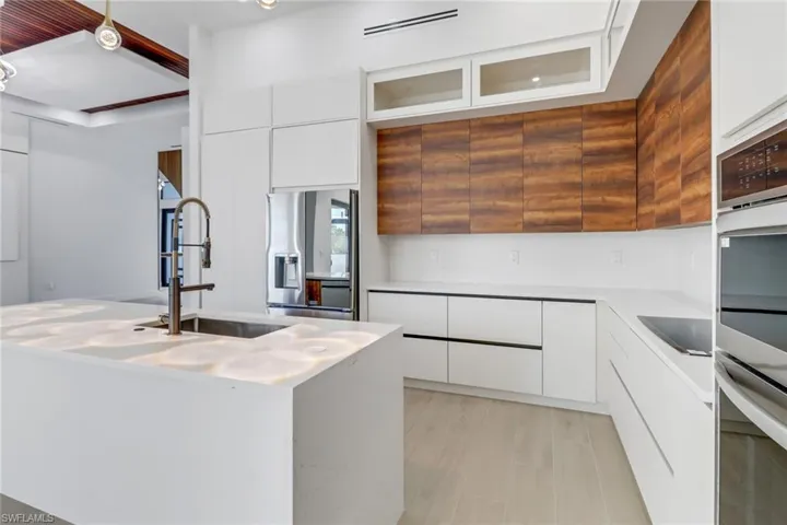Modern kitchen with quartz counters, custom cabinets, stainless appliance package.