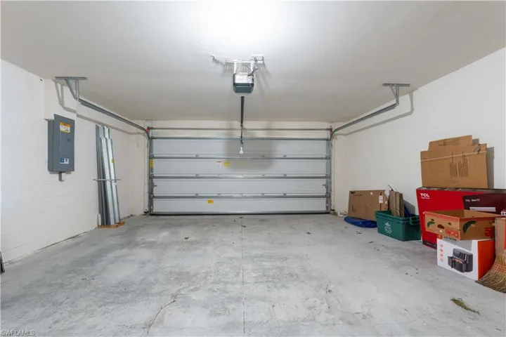 Garage with a garage door opener and electric panel
