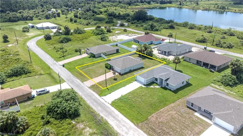 Birds eye view of property with a water view