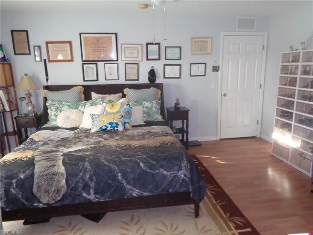 Bedroom featuring wood finished floors and a ceiling fan