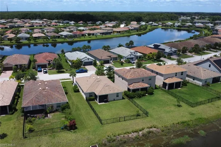 Drone / aerial view with a residential view and a water view