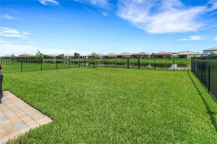 View of yard featuring a water view and fence private yard