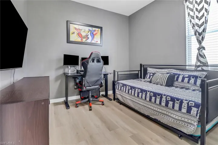 Bedroom with baseboards and wood finished floors